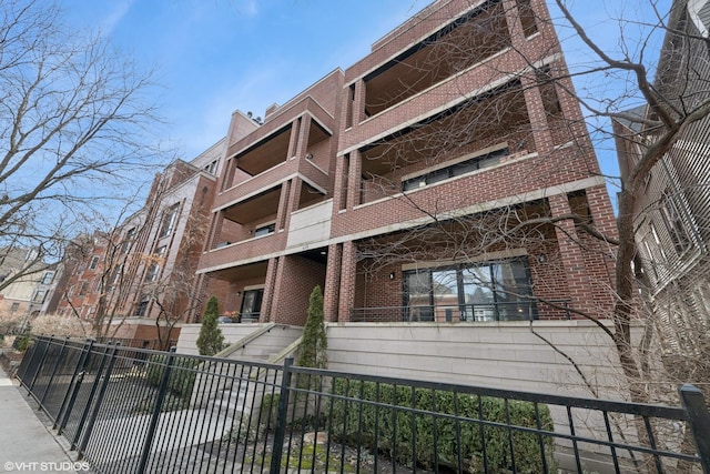 view of building exterior with fence