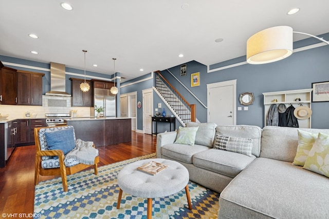 living area featuring stairway, dark wood-style flooring, and recessed lighting