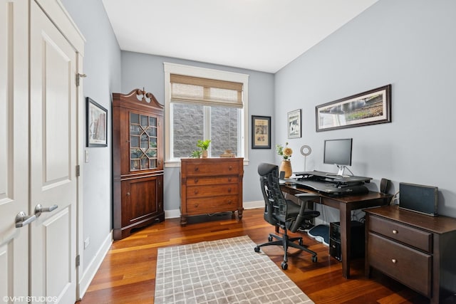 home office with baseboards and wood finished floors