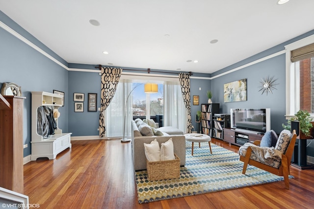 living area with recessed lighting, wood finished floors, and baseboards