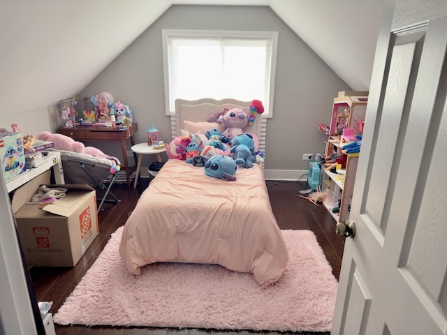 bedroom featuring dark wood-style floors, lofted ceiling, and baseboards