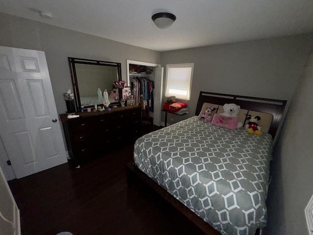 bedroom featuring a closet and dark wood-style flooring