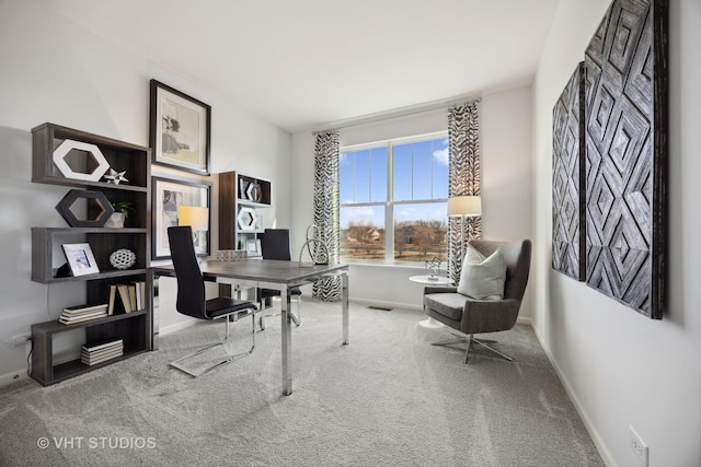 office space with baseboards and carpet flooring