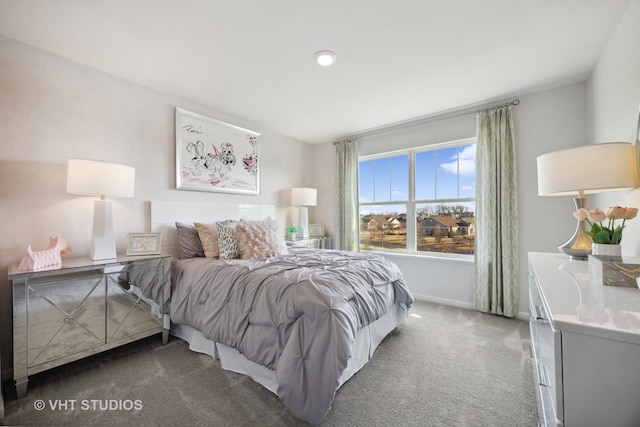 carpeted bedroom featuring baseboards