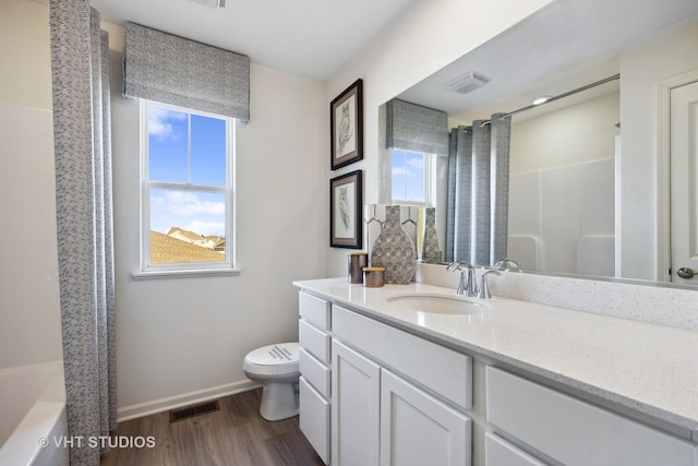 bathroom with visible vents, baseboards, toilet, and wood finished floors