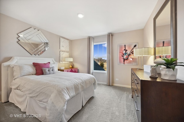 bedroom featuring light colored carpet and baseboards