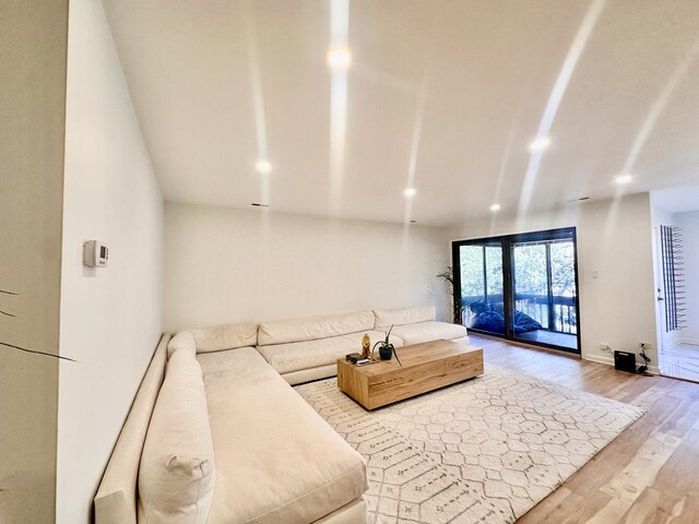 living area featuring recessed lighting, wood finished floors, and baseboards