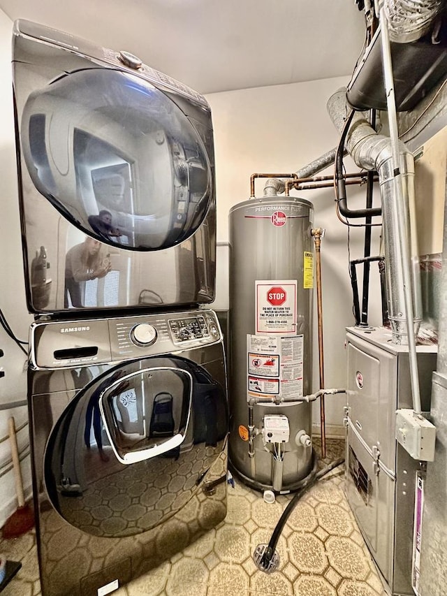 utility room featuring stacked washer / drying machine, gas water heater, and heating unit