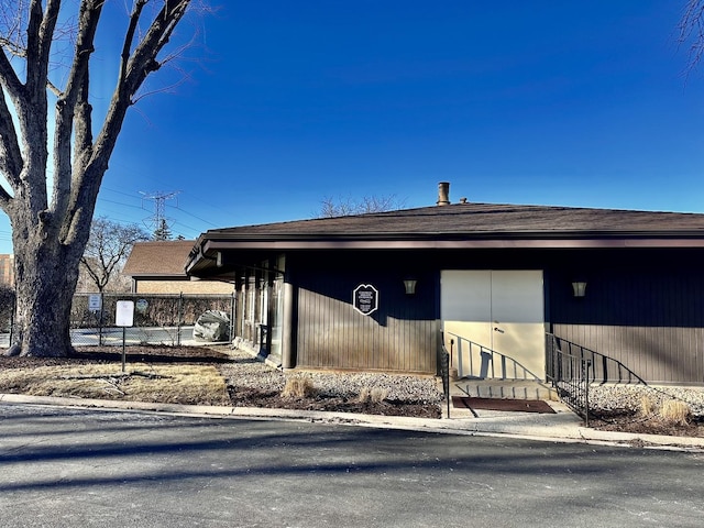 view of front of house featuring fence