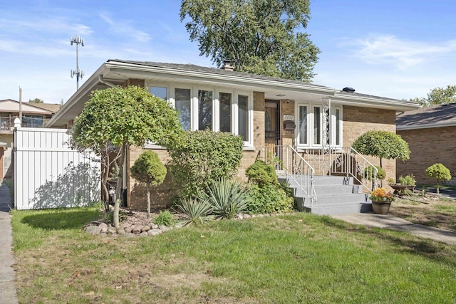 ranch-style house with brick siding and a front yard