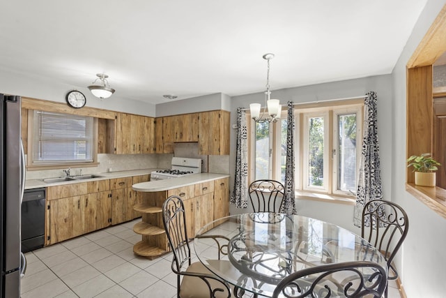 kitchen featuring dishwasher, white gas range, light countertops, open shelves, and a sink