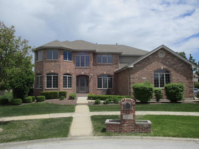 8032 Abbey Rd, Tinley Park, IL 60477 - view of front facade with a front yard, brick siding, and roof with shingles