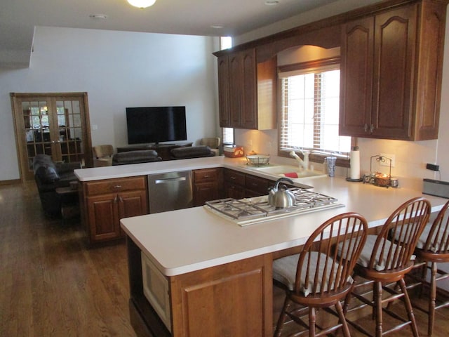 8032 Abbey Rd, Tinley Park, IL 60477 - kitchen featuring a peninsula, stainless steel appliances, light countertops, and dark wood-style flooring