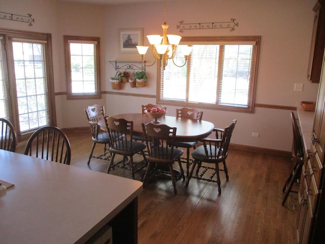 8032 Abbey Rd, Tinley Park, IL 60477 - dining space with dark wood-style flooring, a chandelier, and baseboards