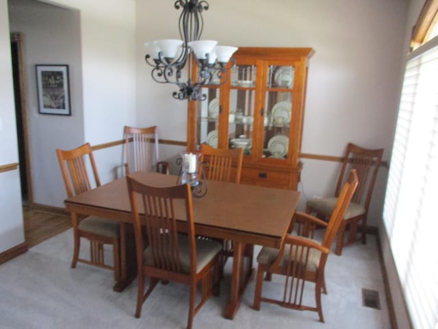 8032 Abbey Rd, Tinley Park, IL 60477 - dining space with a chandelier, light colored carpet, and baseboards