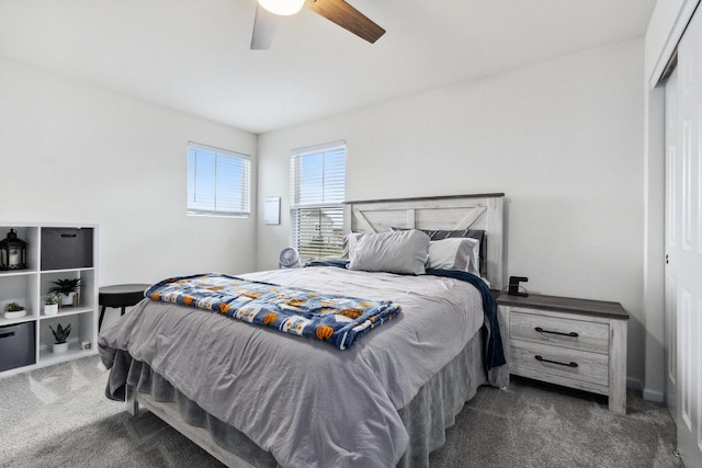 carpeted bedroom with a closet and a ceiling fan