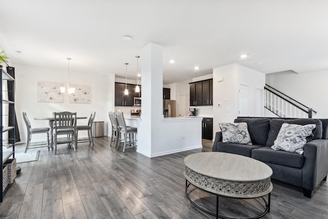 living room with dark wood-style floors, stairway, baseboards, and recessed lighting