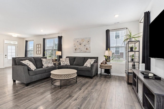 living room featuring dark wood-style floors, recessed lighting, and baseboards