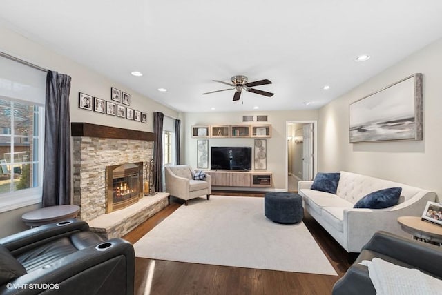 living area with recessed lighting, a fireplace, plenty of natural light, and wood finished floors