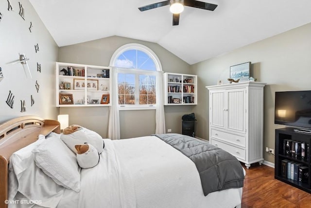 bedroom featuring a ceiling fan, vaulted ceiling, baseboards, and wood finished floors