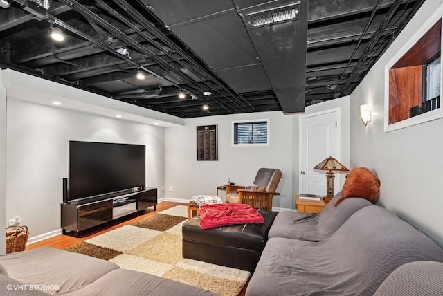 home theater room with visible vents, baseboards, and wood finished floors