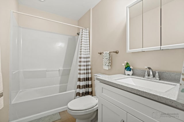 bathroom with shower / bath combo, vanity, and toilet