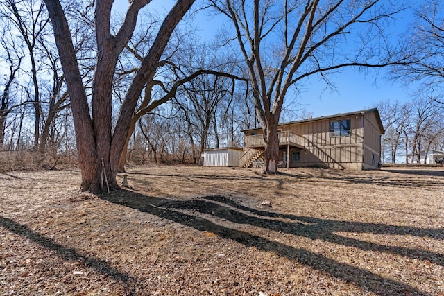 view of yard featuring stairs and a wooden deck