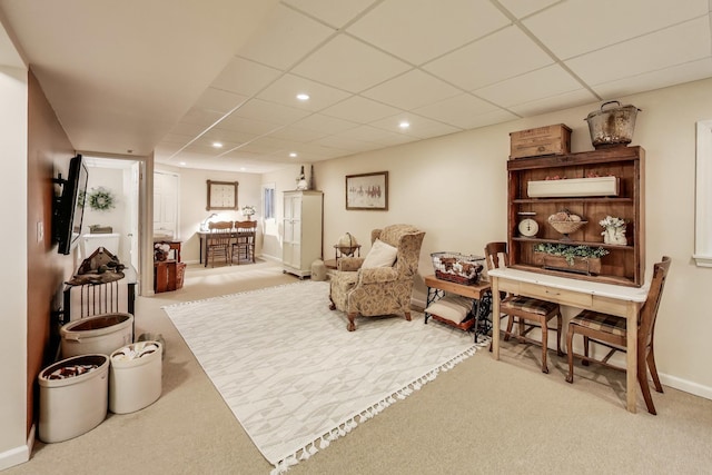 sitting room featuring a paneled ceiling, light carpet, baseboards, and recessed lighting