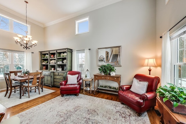 sitting room featuring plenty of natural light, dark wood finished floors, and crown molding