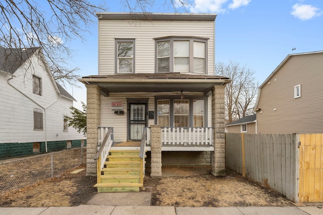 view of front facade with a porch and fence