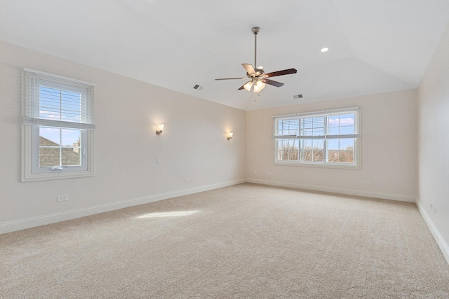 unfurnished room featuring visible vents, baseboards, a wealth of natural light, and light colored carpet