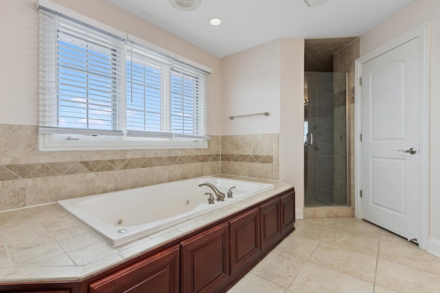 full bath featuring a tub with jets, tile patterned flooring, and a shower stall