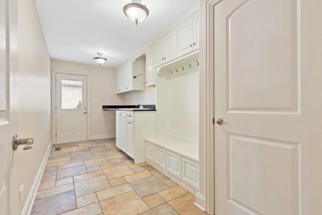 bathroom featuring toilet, vanity, and baseboards