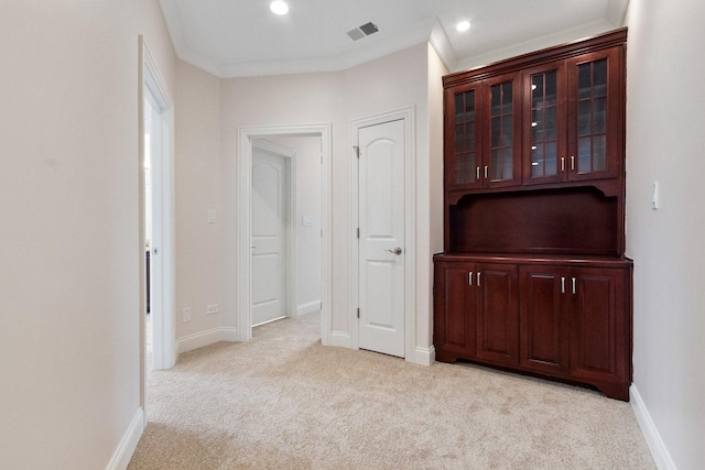 hallway featuring baseboards, visible vents, light colored carpet, crown molding, and recessed lighting