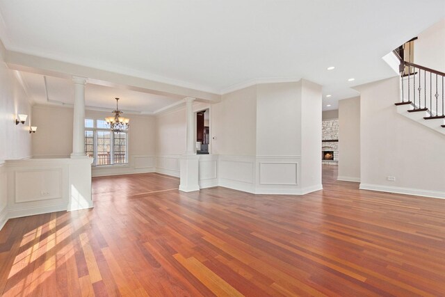 unfurnished dining area featuring crown molding, dark wood-type flooring, and a notable chandelier