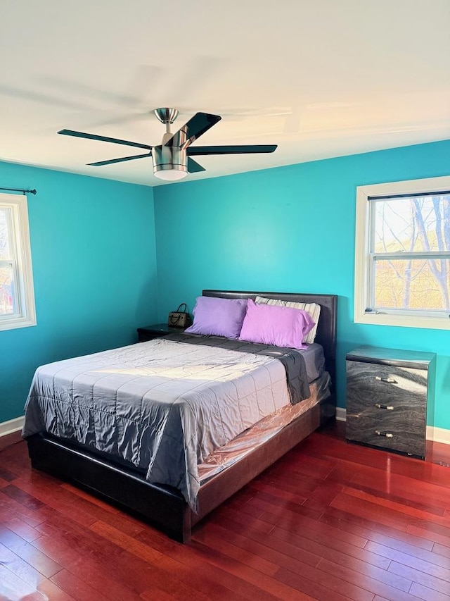 bedroom with ceiling fan, baseboards, and hardwood / wood-style floors