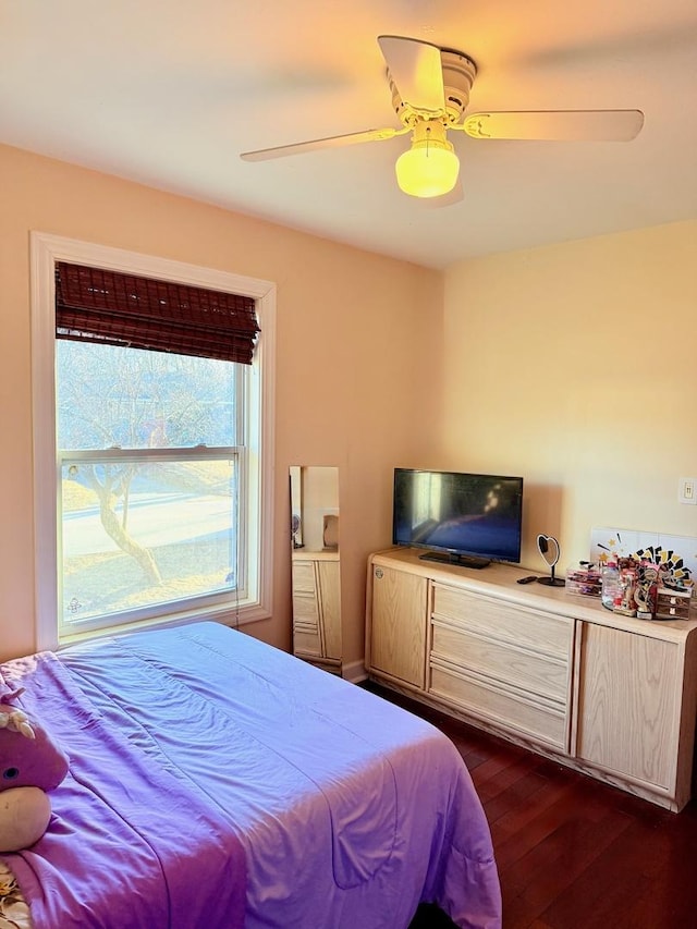 bedroom with ceiling fan and dark wood-style flooring