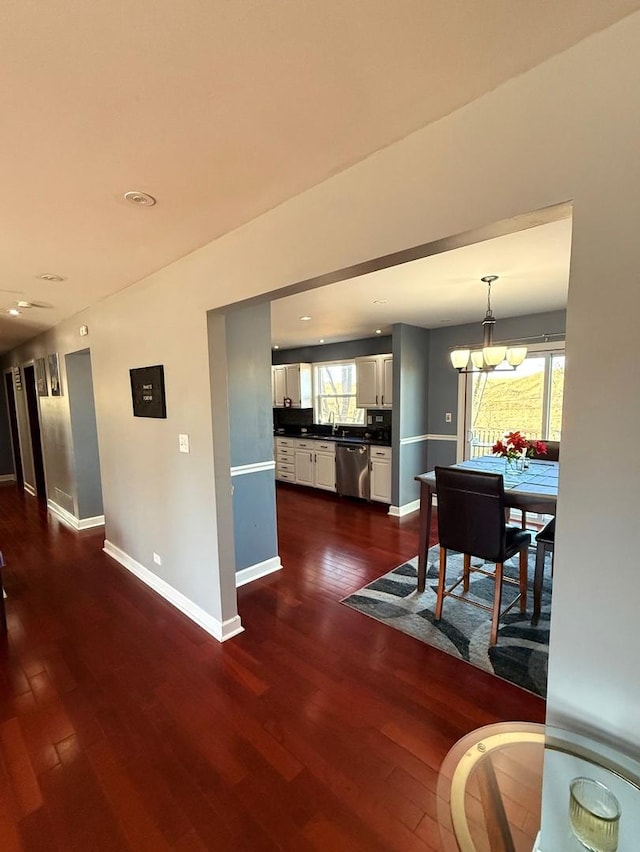 interior space with baseboards, a chandelier, dark wood-style flooring, and recessed lighting