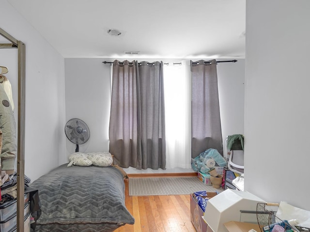 bedroom featuring wood-type flooring and visible vents