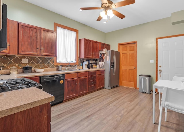 kitchen with decorative backsplash, light wood-style floors, a sink, stainless steel fridge, and dishwasher