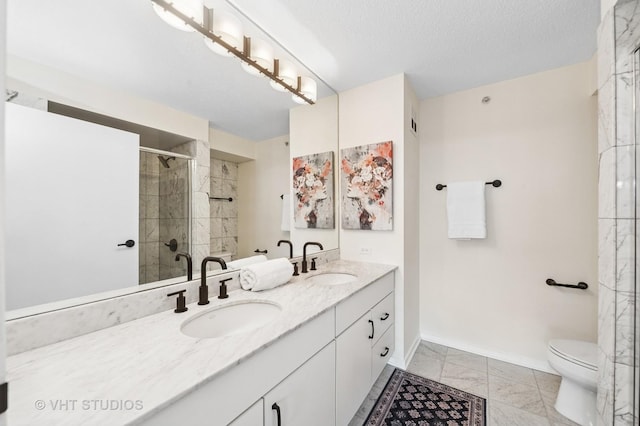 full bath with marble finish floor, a sink, a shower stall, and baseboards