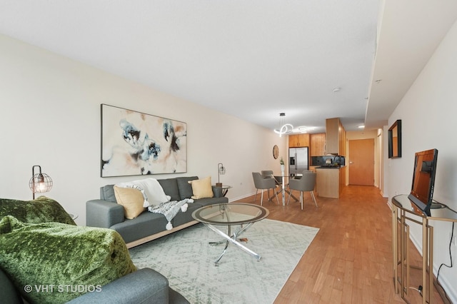 living room with light wood finished floors and baseboards