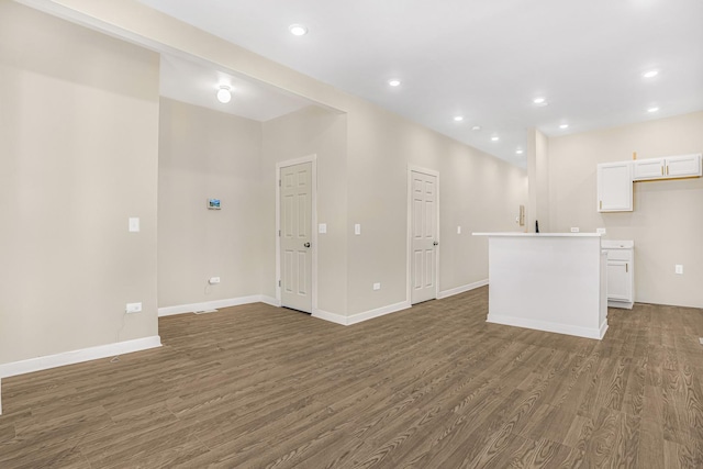 interior space featuring recessed lighting, baseboards, and wood finished floors