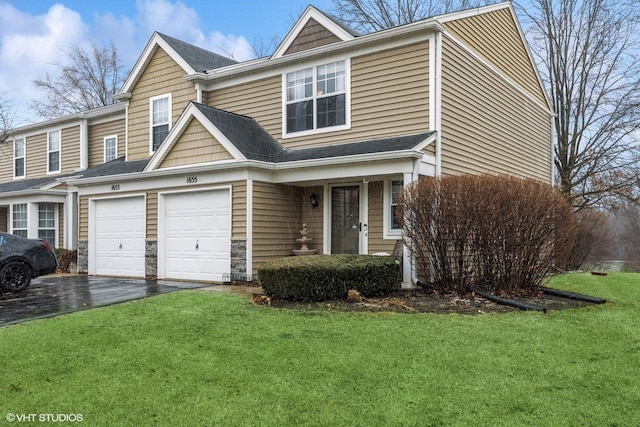 view of front of home with driveway and a front lawn