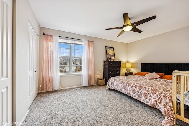 bedroom with carpet, a closet, visible vents, ceiling fan, and baseboards