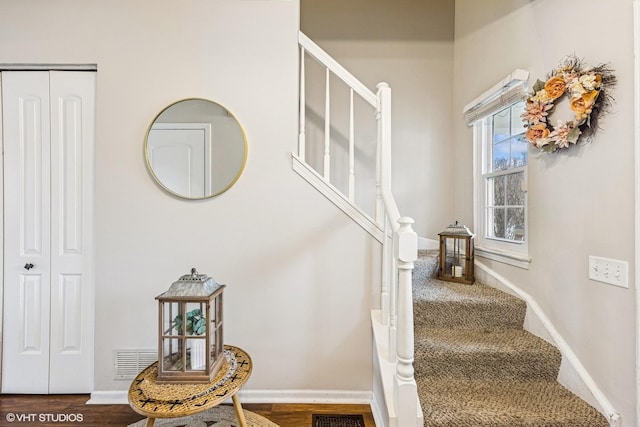 stairway with baseboards and wood finished floors