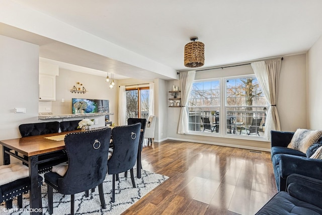 dining room with baseboards and wood finished floors