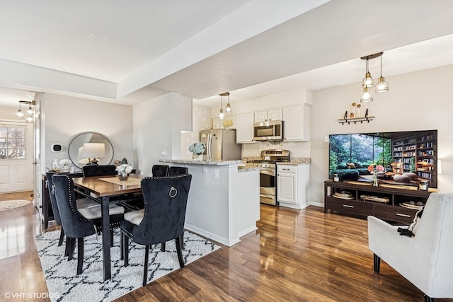 dining room with baseboards and wood finished floors