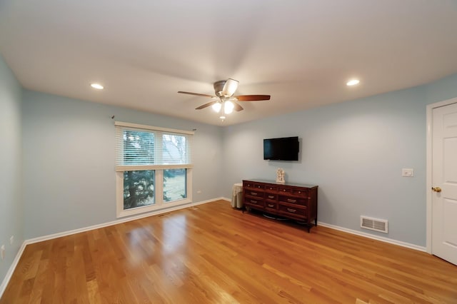 unfurnished living room featuring visible vents, ceiling fan, baseboards, and wood finished floors