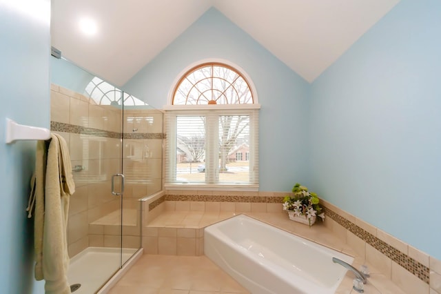 full bathroom with lofted ceiling, a stall shower, tile patterned flooring, and a bath